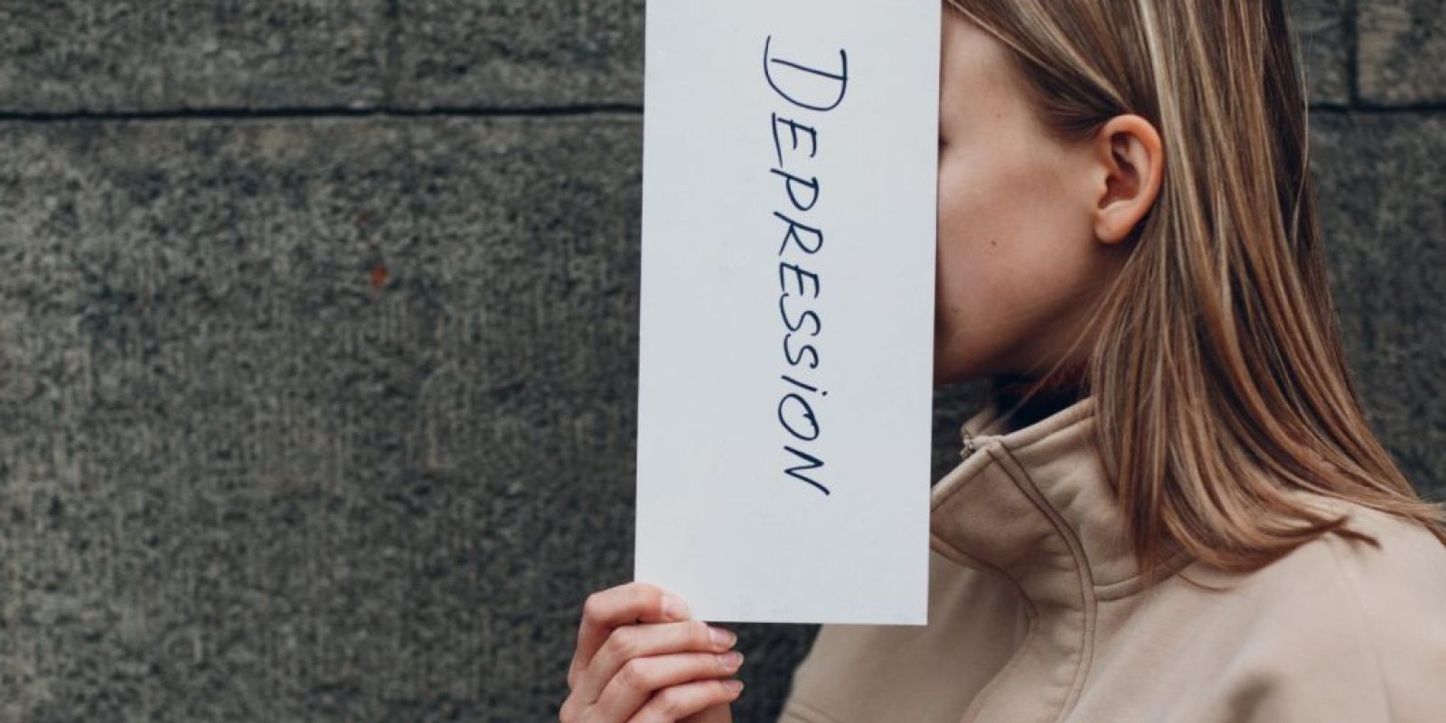 signs of depression-images-of-a-person-holding-a-paer-with-the-word-depression-written-of-it.when-you-experience-depression-signs-and-symptoms-ensure-to-seek-treat-and-help-as-soon-as-possible.