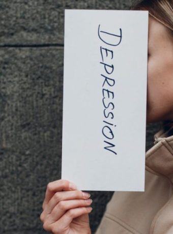 signs of depression-images-of-a-person-holding-a-paer-with-the-word-depression-written-of-it.when-you-experience-depression-signs-and-symptoms-ensure-to-seek-treat-and-help-as-soon-as-possible.