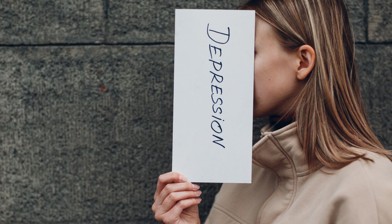 signs of depression-images-of-a-person-holding-a-paer-with-the-word-depression-written-of-it.when-you-experience-depression-signs-and-symptoms-ensure-to-seek-treat-and-help-as-soon-as-possible.